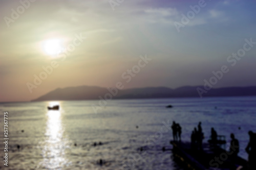 Bright sunset with large yellow sun under the sea surface  the image does not focus and blurred