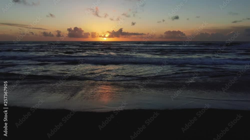 Blazing colors of sunset beach, rhythmically beaten by Pacific Ocean Waves. Natural golden saturation.  Drone based aerial footage. Cinematic and beautiful. calming and Relaxed Euphoric  camping
