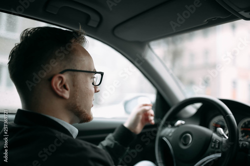 male driver businessman with glasses inside a car © velimir