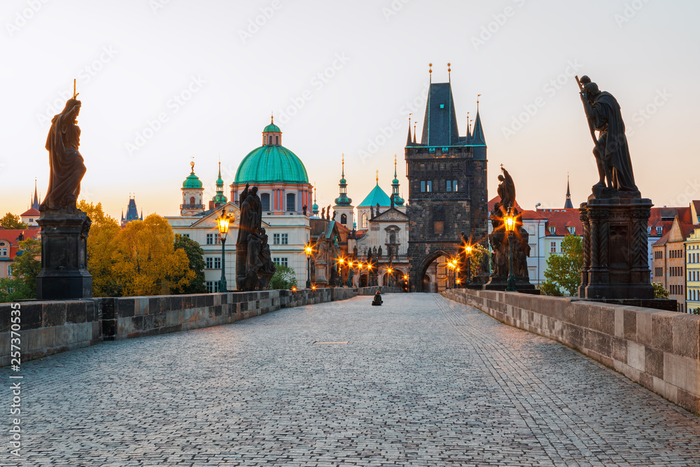 Obraz premium Scenic view on Vltava rive, Charles bridge and historical center of Prague, buildings and landmarks of old town at sunset, Prague, Czech Republic