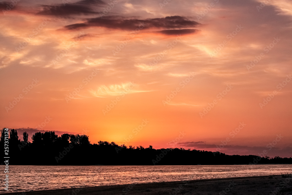 river bank at sunrise, beautiful sky in sunset colors, orange and pink shades river bank at sunrise, beautiful sky in sunset colors, orange and pink shades