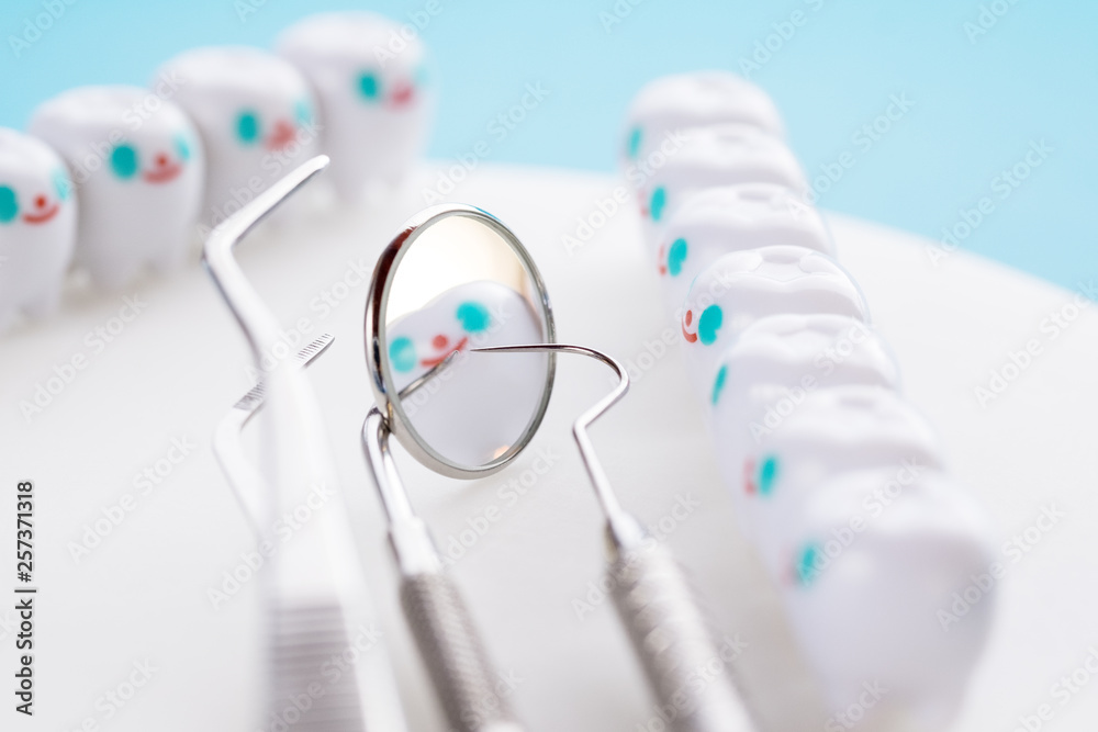 Close up.Dentist tools and smile teeth model on white background.
