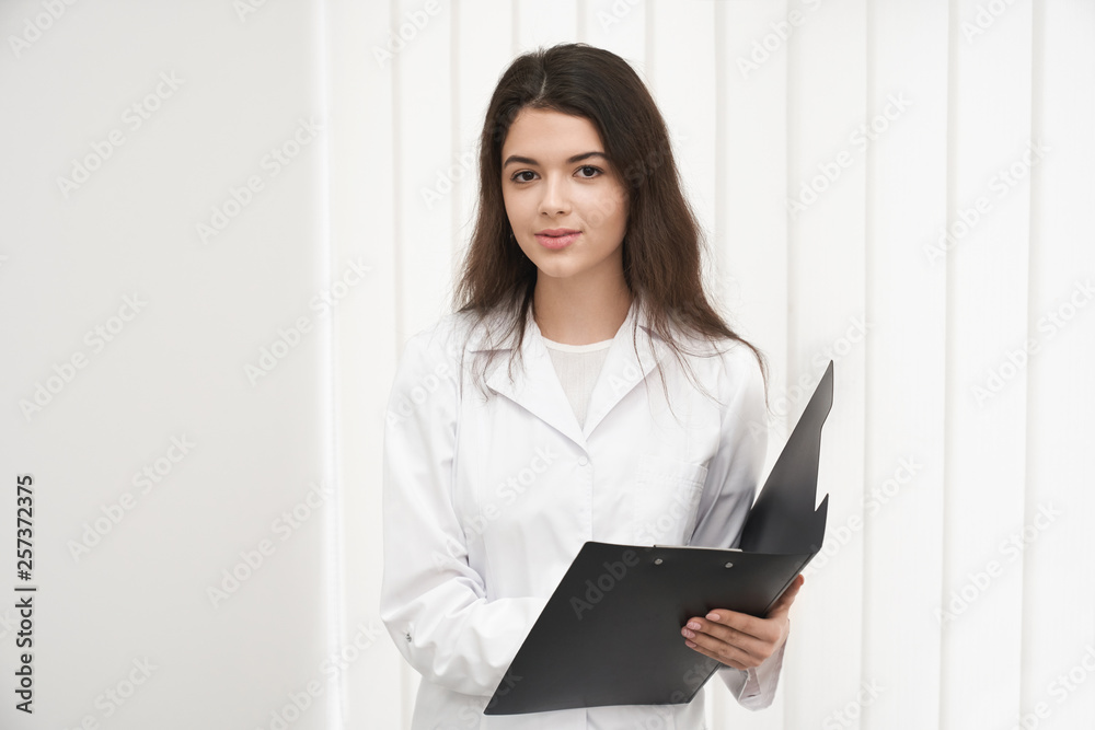 Pretty woman in medical gown working as doctor in clinic. Pretty woman in medical gown working as doctor in clinic.