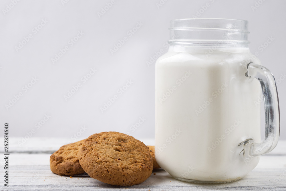 Milk with cookies on wooden white background Milk with cookies on wooden white background