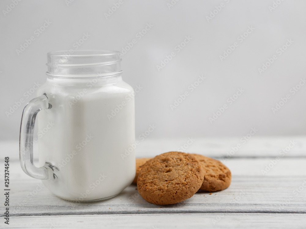 oatmeal cookies with milk on wooden background oatmeal cookies with milk on wooden background