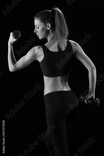 fitness woman in doing exercises with dumbells. © zhagunov_a