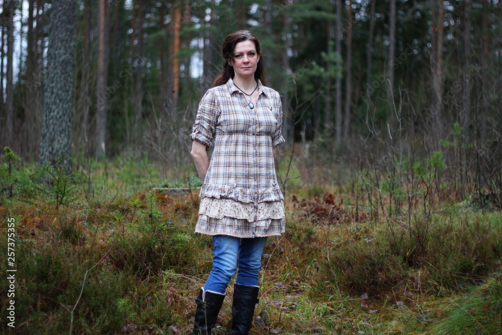 A woman standing in a forest A woman standing in a forest
