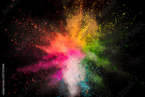 Colored powder explosion on black background. Freeze motion.