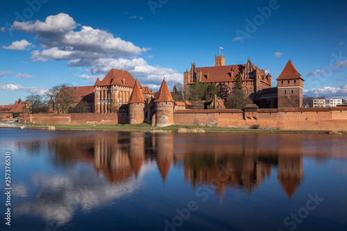 Teutonic castle and its reflection in Nogat river in Malbork, Pomorskie, Poland photo
