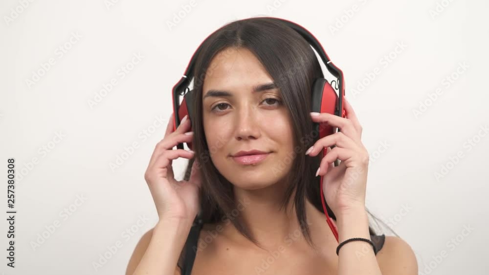 Demonstration video of a young woman wearing headphones, listening to music and dancing to beat drop rhythm Demonstration video of a young woman wearing headphones, listening to music and dancing to beat drop rhythm