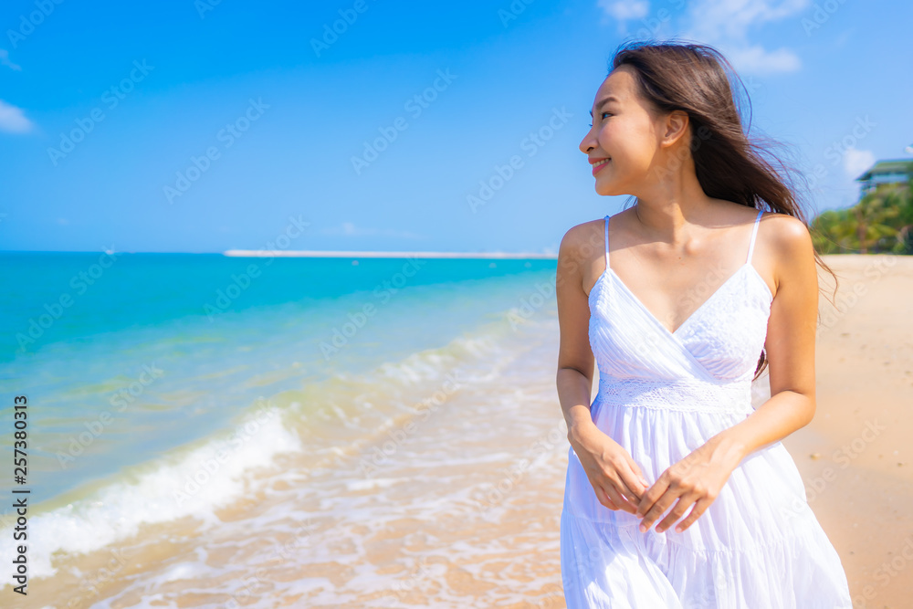 Portrait beautiful young asian woman happy smile leisure on the beach sea and ocean