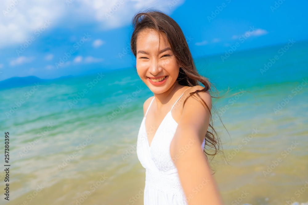 Portrait beautiful young asian woman happy smile leisure on the beach sea and ocean Portrait beautiful young asian woman happy smile leisure on the beach sea and ocean