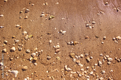 simple background wallpaper pattern concept of sand and stone waterfront shoreline near the sea, copy space