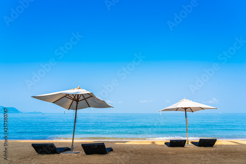 Fototapeta Naklejka Na Ścianę i Meble -  Chair umbrella and lounge on the beautiful beach sea ocean on sky