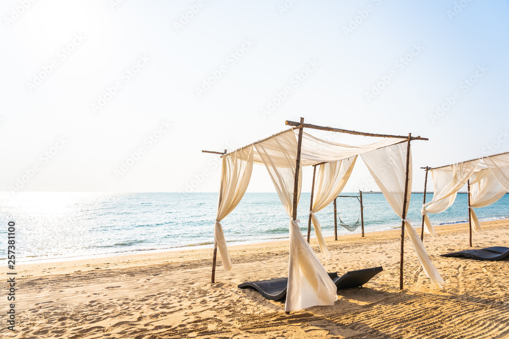 Chair umbrella and lounge on the beautiful beach sea ocean on sky Chair umbrella and lounge on the beautiful beach sea ocean on sky