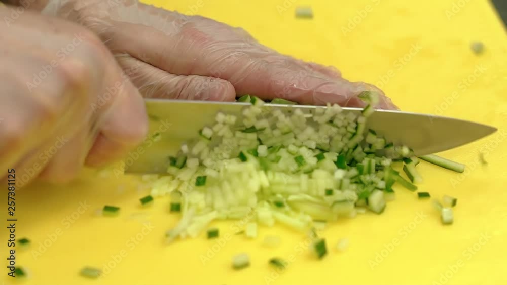 Cook very quickly cuts fresh cucumber in small cubes. Cook very quickly cuts fresh cucumber in small cubes.