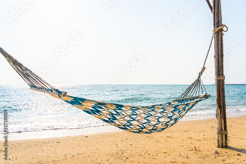 Empty hammock swing on the beautiful beach and sea © siraphol