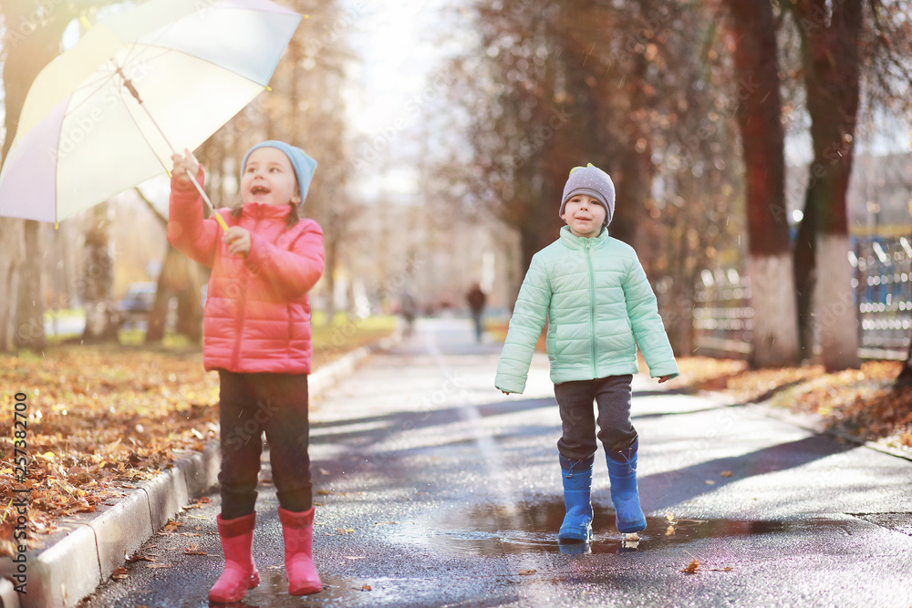 Children walk in the autumn park Children walk in the autumn park