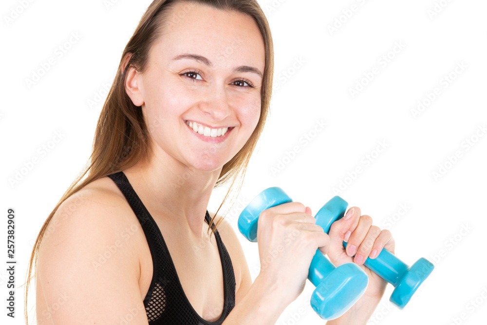 Attractive young woman with blue dumbbells doing crossfit workout Attractive young woman with blue dumbbells doing crossfit workout