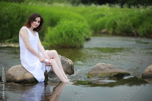 Pregnant woman in nature for a walk in the summer