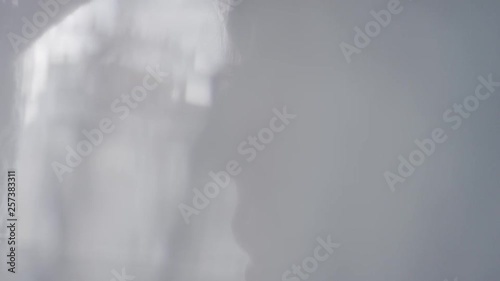 Close-up portrait. Silhouette of a girl in the shade, eyes close-up, the girl blinks. Portrait of a girl behind a veil. Blur. Out of focus. Slow motion, 4K