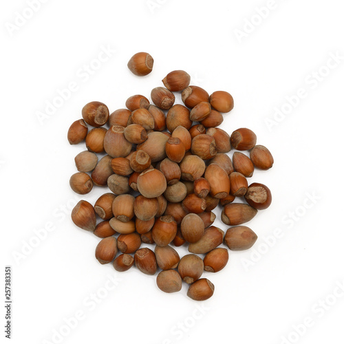 small handful of hazelnuts on a white background