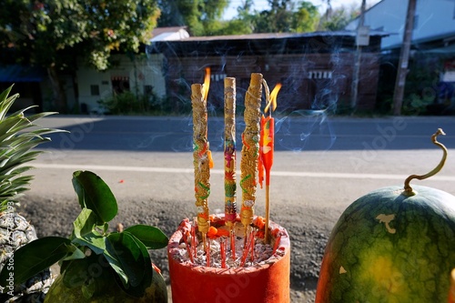 Incense sticks and candlelight are burning in incense pot with sunshine for holy worship are celebrate Chinese New Year, The Spring Festival, Chen Meng photo