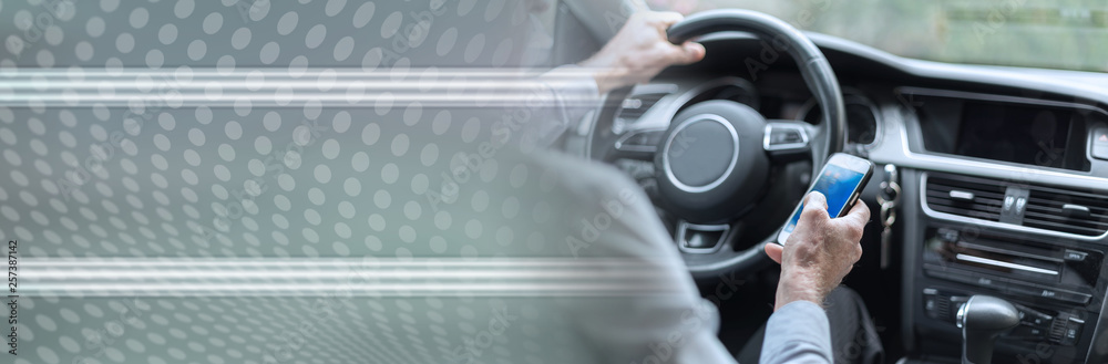 Man using a smartphone and driving. panoramic banner