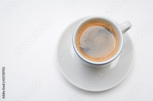 Strong espresso served in white cup and saucer © tommoh29