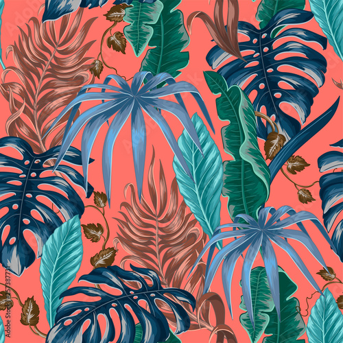 Seamless pattern with tropical banana, palm and monstera leaves for fabric design on living coral background.