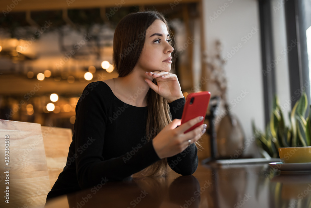 Woman using mobile smart phone in cafe Woman using mobile smart phone in cafe