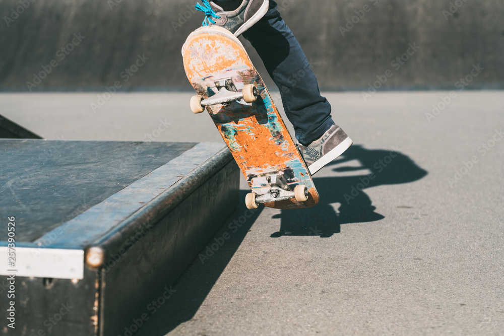 Skateboarding man feet. Sport active life. Guy on skateboard performing trick. park area. Action shot. Stock Photo | Adobe