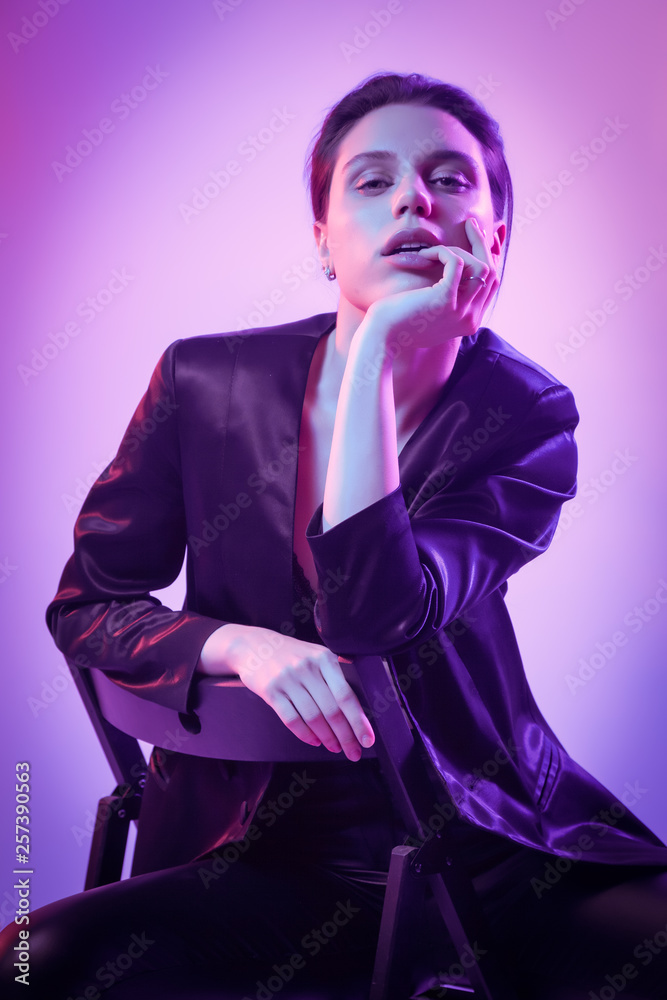 High Fashion model woman in fashion jacket and pants in colorful bright neon uv blue and pink lights, posing in studio. Fashion concept and Zine culture High Fashion model woman in fashion jacket and pants in colorful bright neon uv blue and pink lights, posing in studio. Fashion concept and Zine culture