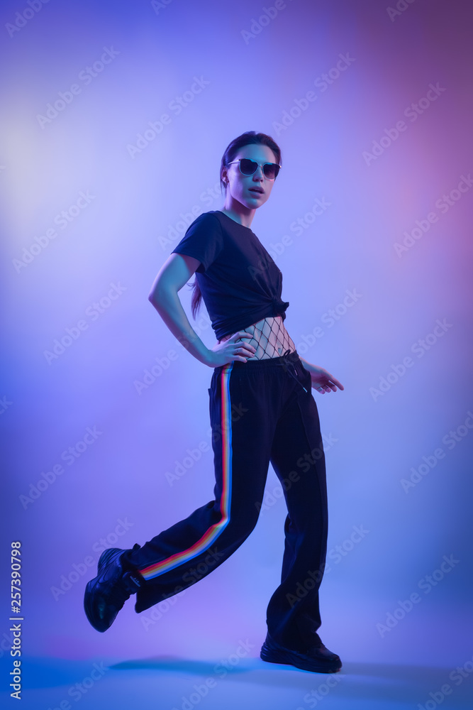Cinematic night portrait of woman in  neon. Art Fashion photo of elegant model  in the light colored spotlights.Fashion concept and Zine culture