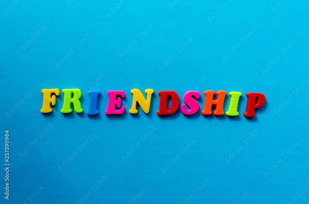 text friendship from plastic colored letters on blue paper background text friendship from plastic colored letters on blue paper background