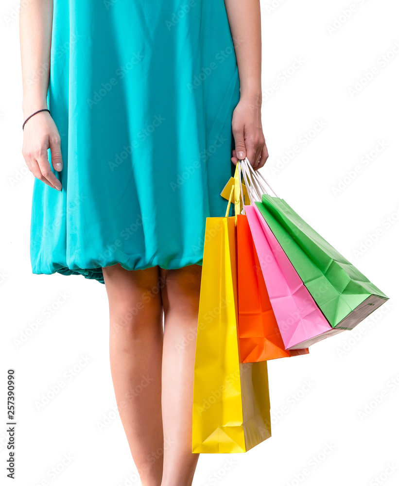 Photo of woman in blue skirt with colorful packages standing on empty white background.