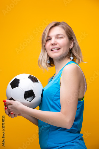 Photo of blonde with soccer ball on yellow background © nuclear_lily