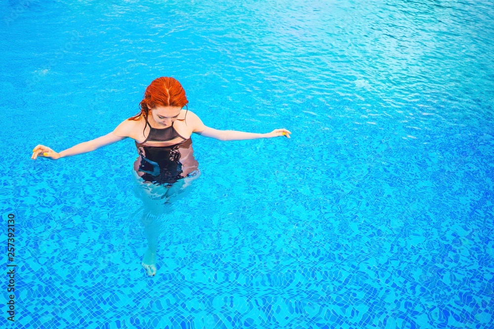 Woman swimming in the pool.