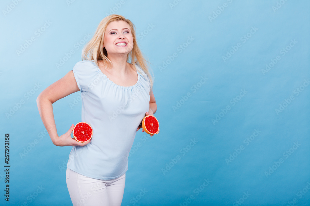 Woman holds grapefruit citrus fruit in hands Woman holds grapefruit citrus fruit in hands