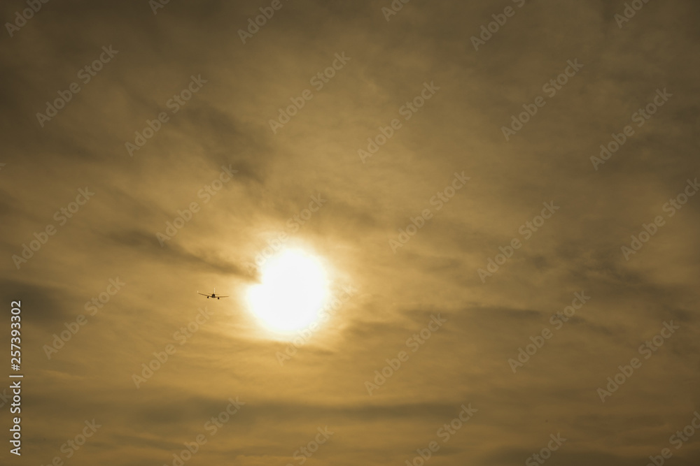 Airplane flying above tropical sea at sunset Airplane flying above tropical sea at sunset