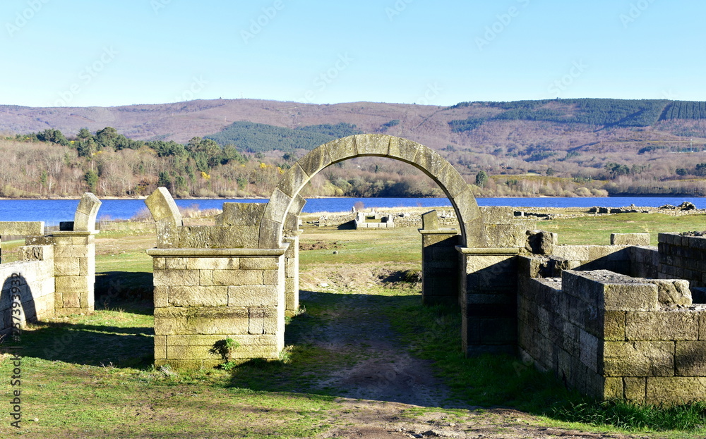 Roman ruins with lake. Aquis Querquennis archaeological site, arched stone door. Baños de Bande, Orense, Spain.
