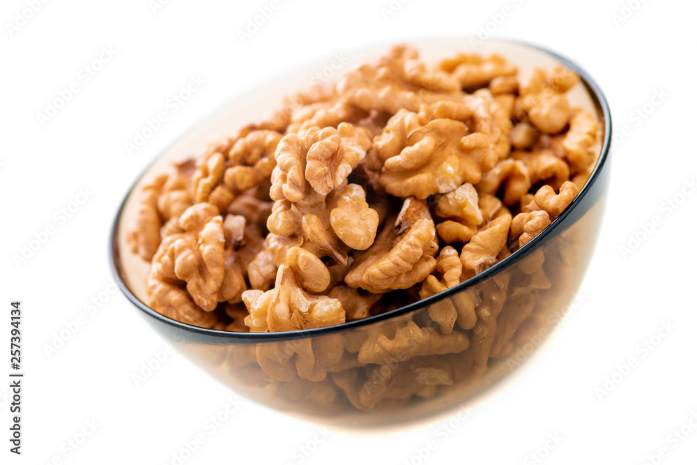 Studio photo of bowl with heap of peeled walnuts isolated on white Studio photo of bowl with heap of peeled walnuts isolated on white