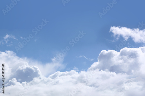 Fluffy white clouds on the background of blue sky