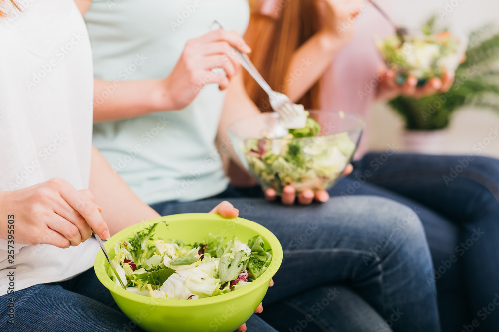 Clean eating. Organic recipe. Healthy whole food nutrition. Green salad bowls in female hands.