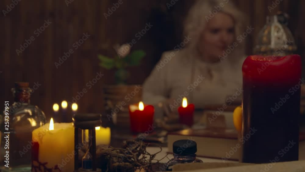 Girl reading books on desk with candle light Girl reading books on desk with candle light