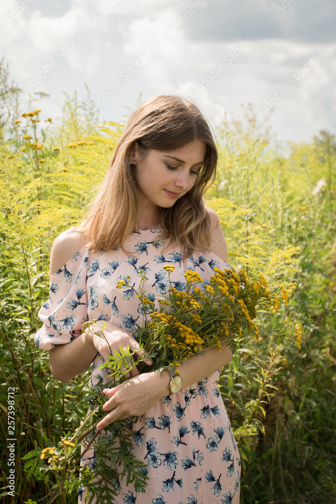 charming girl among the grasses in the summer charming girl among the grasses in the summer