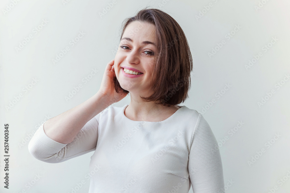 Obraz premium Happy girl smiling. Beauty portrait young happy positive laughing brunette woman on white background isolated. European woman. Positive human emotion facial expression body language
