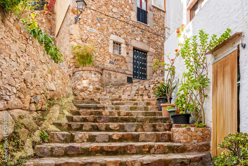 Fototapeta Naklejka Na Ścianę i Meble -  Spain, Tossa de Mar, cobbled street in medieval Old Town - Vila Vella