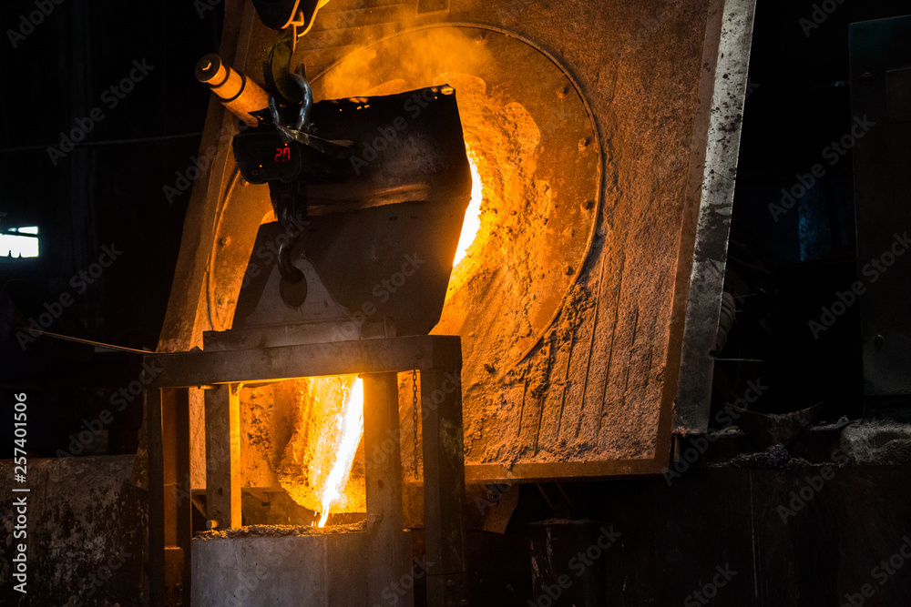 Obraz premium metal casting process with red high temperature fire in metal part factory