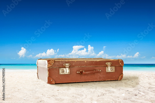 Summer suitcase on beach and sea landscape 